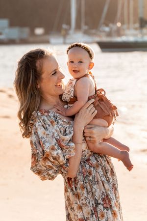 baby daughter and her mom giggling during a photoshoot in Sydney Northern Beaches