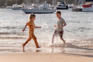 siblings playing in the water at Clontarf Beach Family Photoshoot