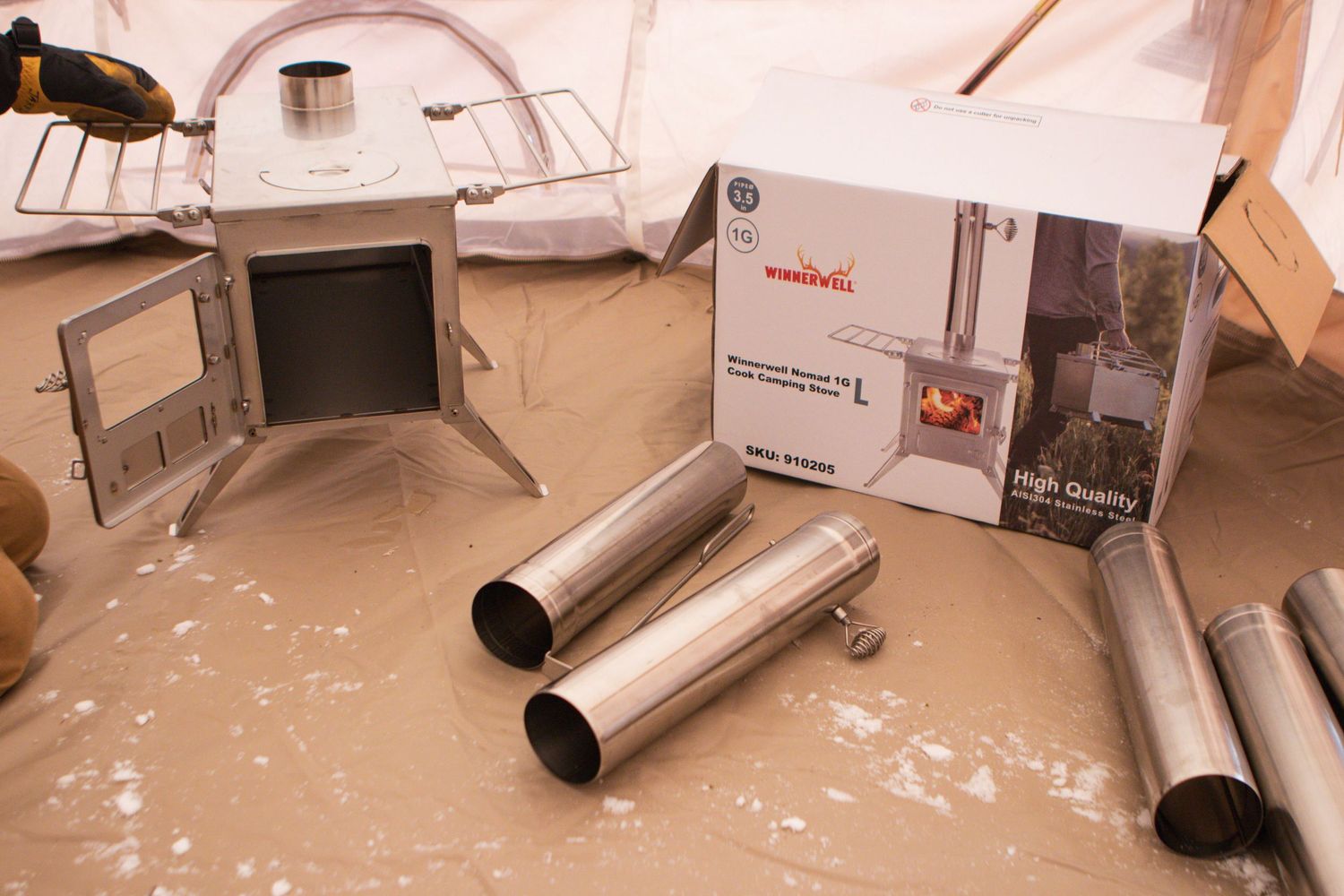 Metal flue pipe components and installation manual laid out on floor.