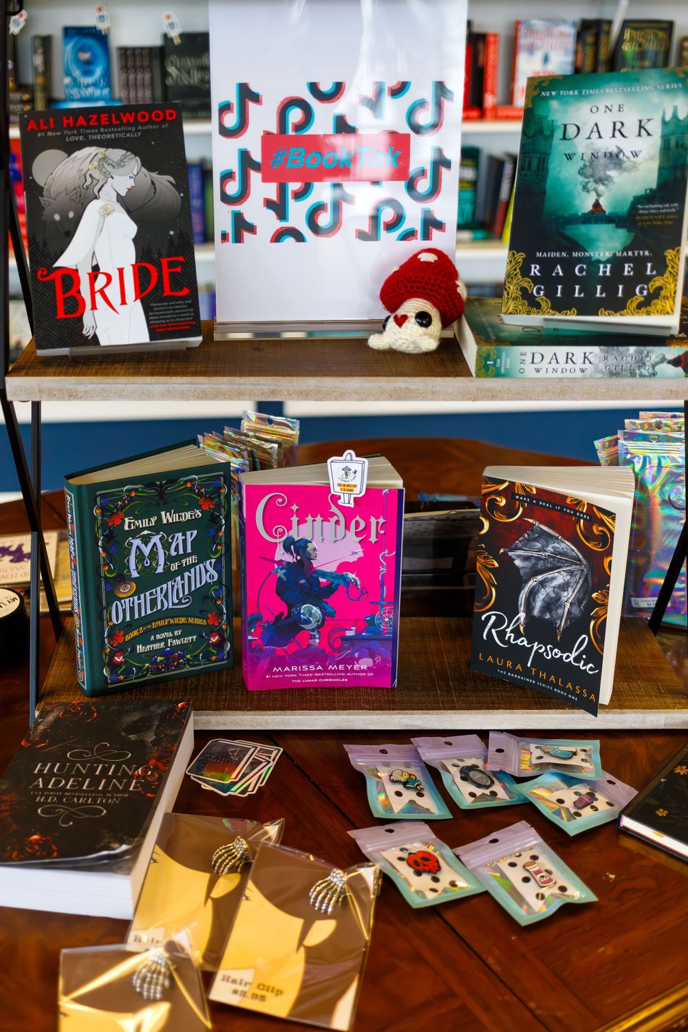 Bookshelf displaying various dark fantasy novels and playing cards.