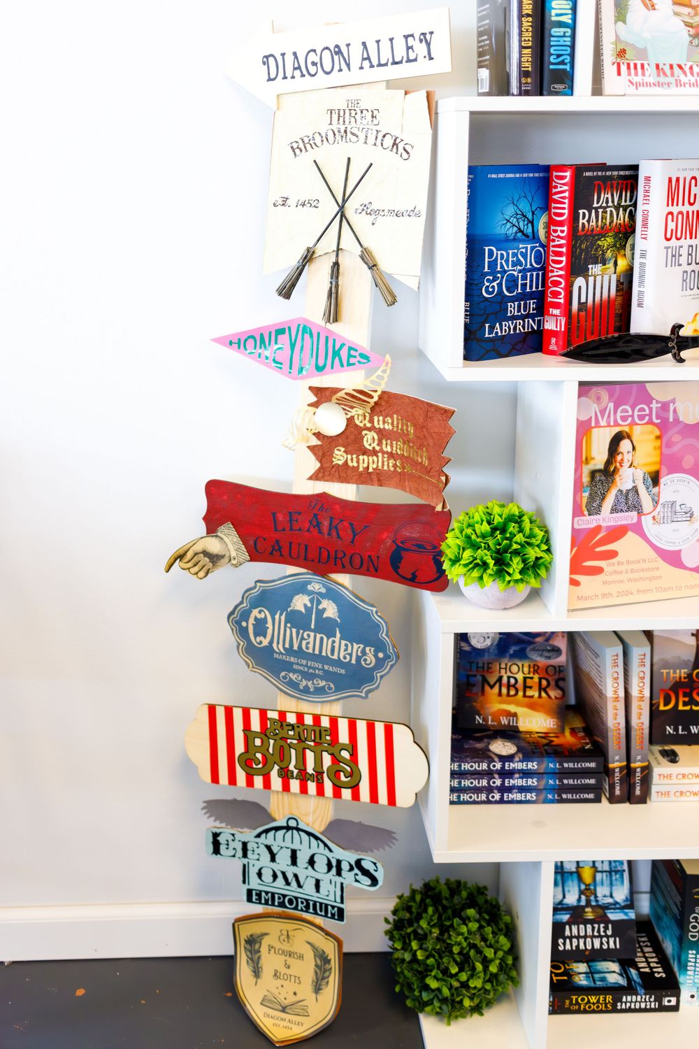 Harry Potter themed directional signs and decorations on bookstore wall.