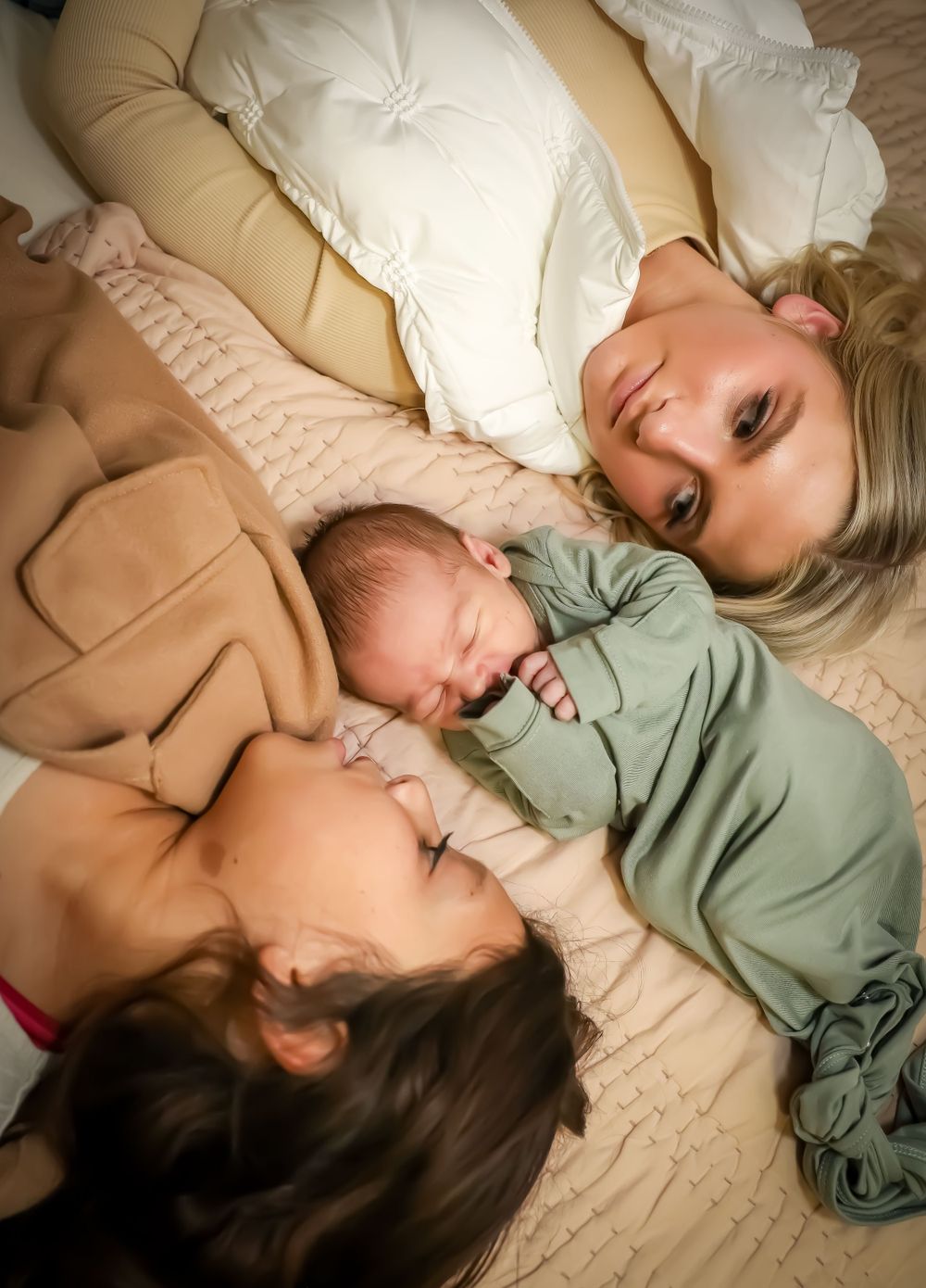 Candid lifestyle photos of children napping together on beige couch with soft pillows.