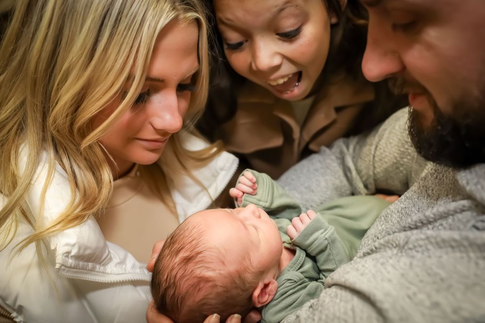 Family lifestyle photography series showing tender moments with newborn baby.