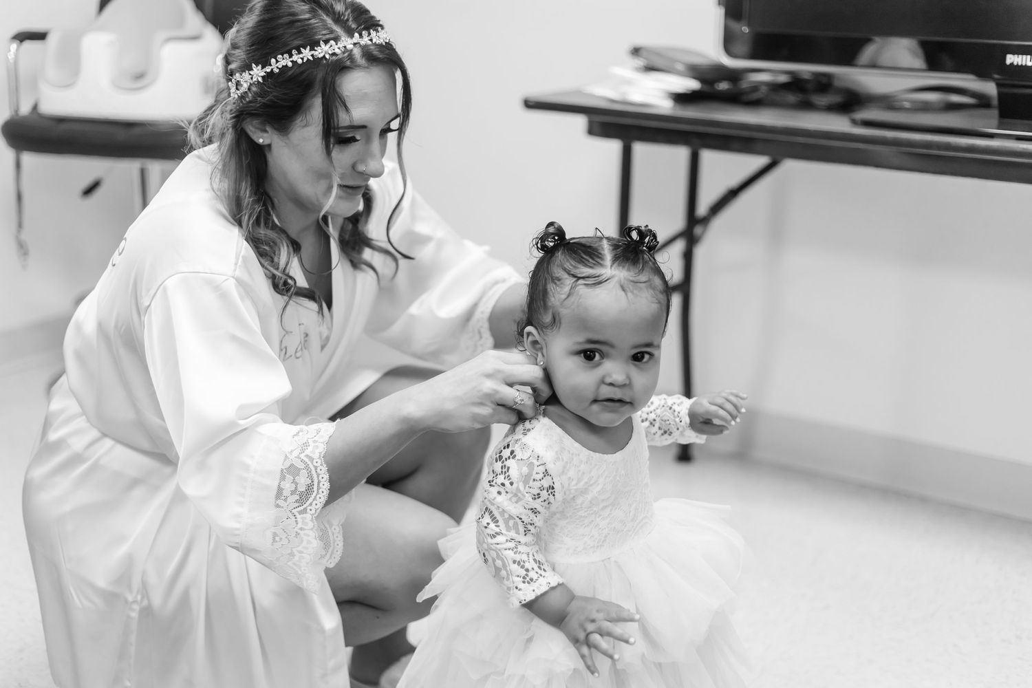 Black and white photo of wedding preparations showing attendees getting ready.