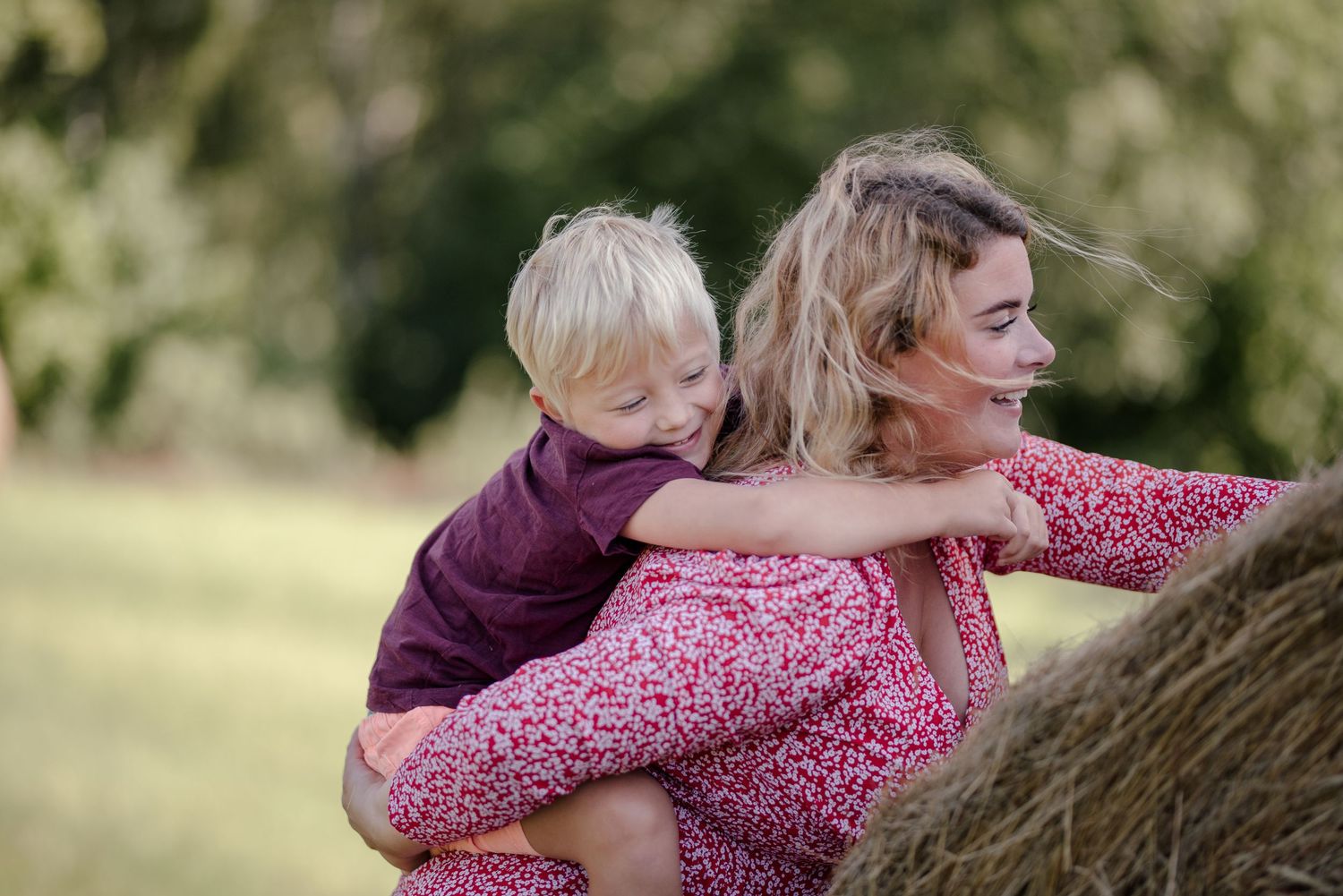 Playful piggyback ride moment shared in a garden setting.