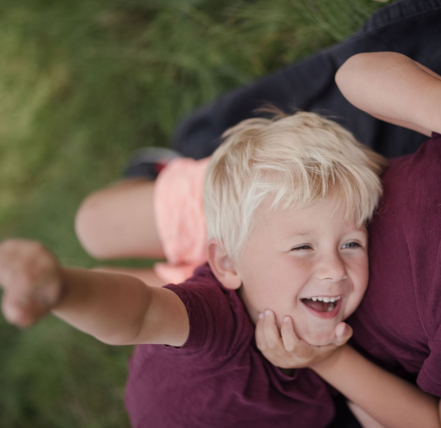 Candid moment of pure happiness and laughter during outdoor playtime.