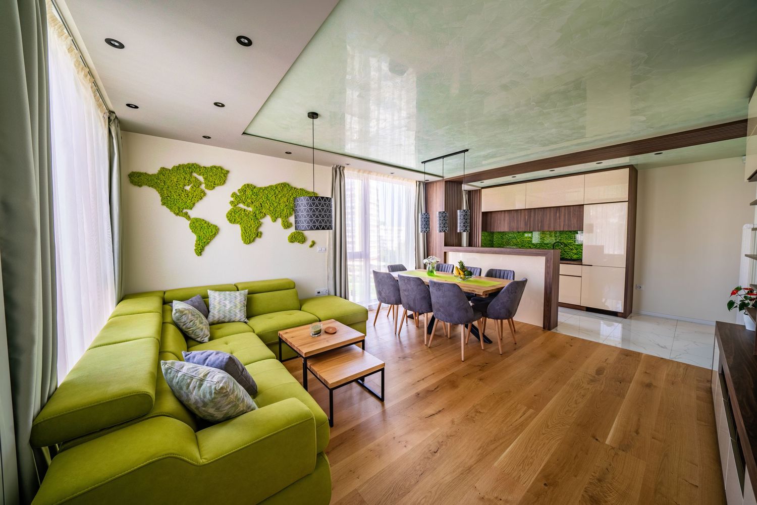 Modern living room interior with green sofa and world map wall art.