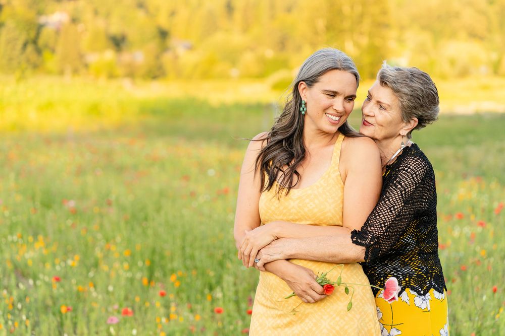 Mother daughter smiling in a wildflower field in Woodinville.