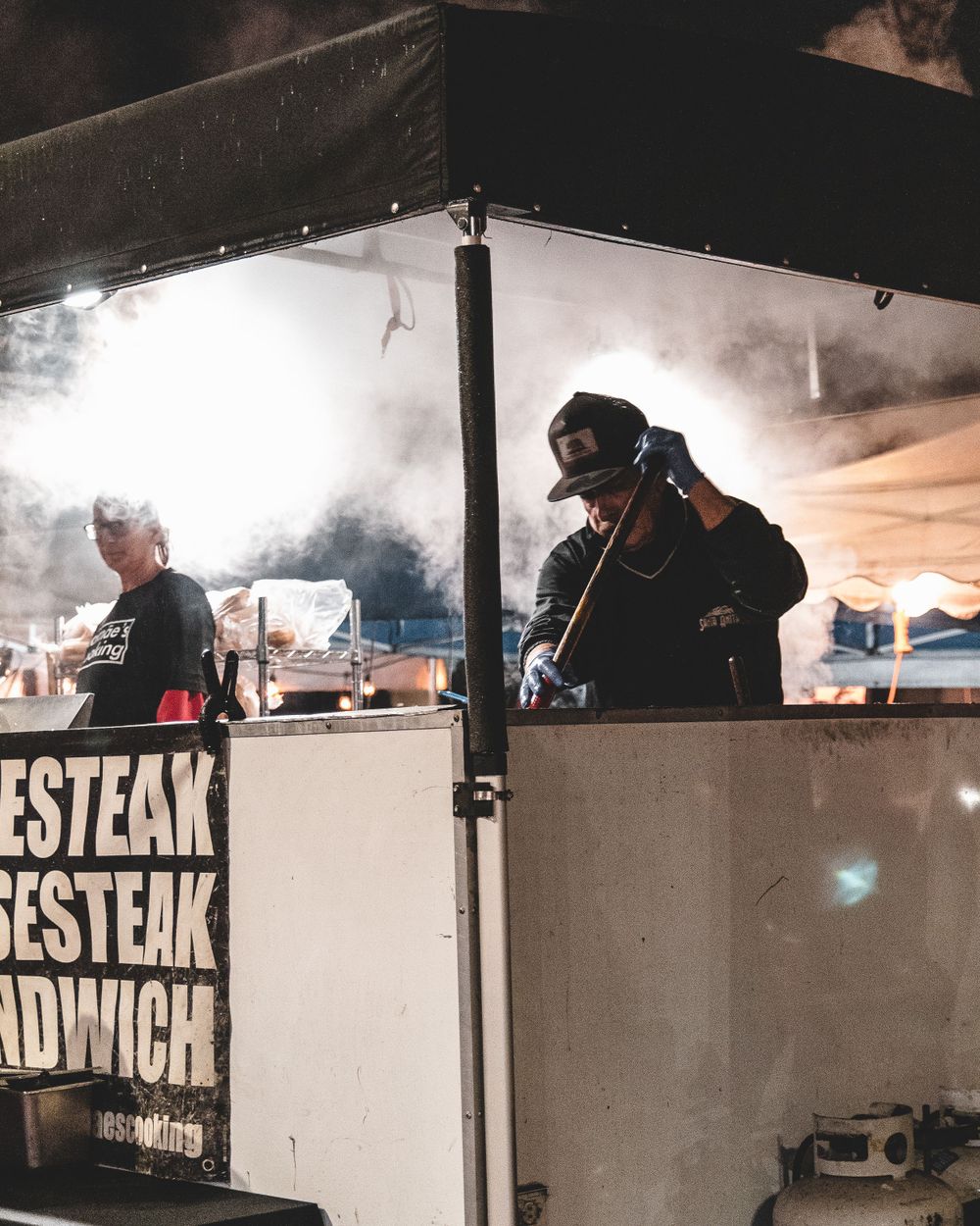 man grilling food at oceanside sunset market in oceanside, ca