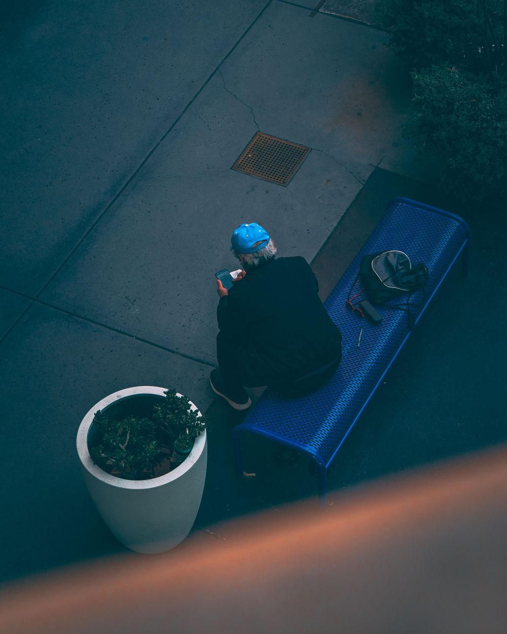 man sitting on bench in abandoned mall in downtown san diego, ca