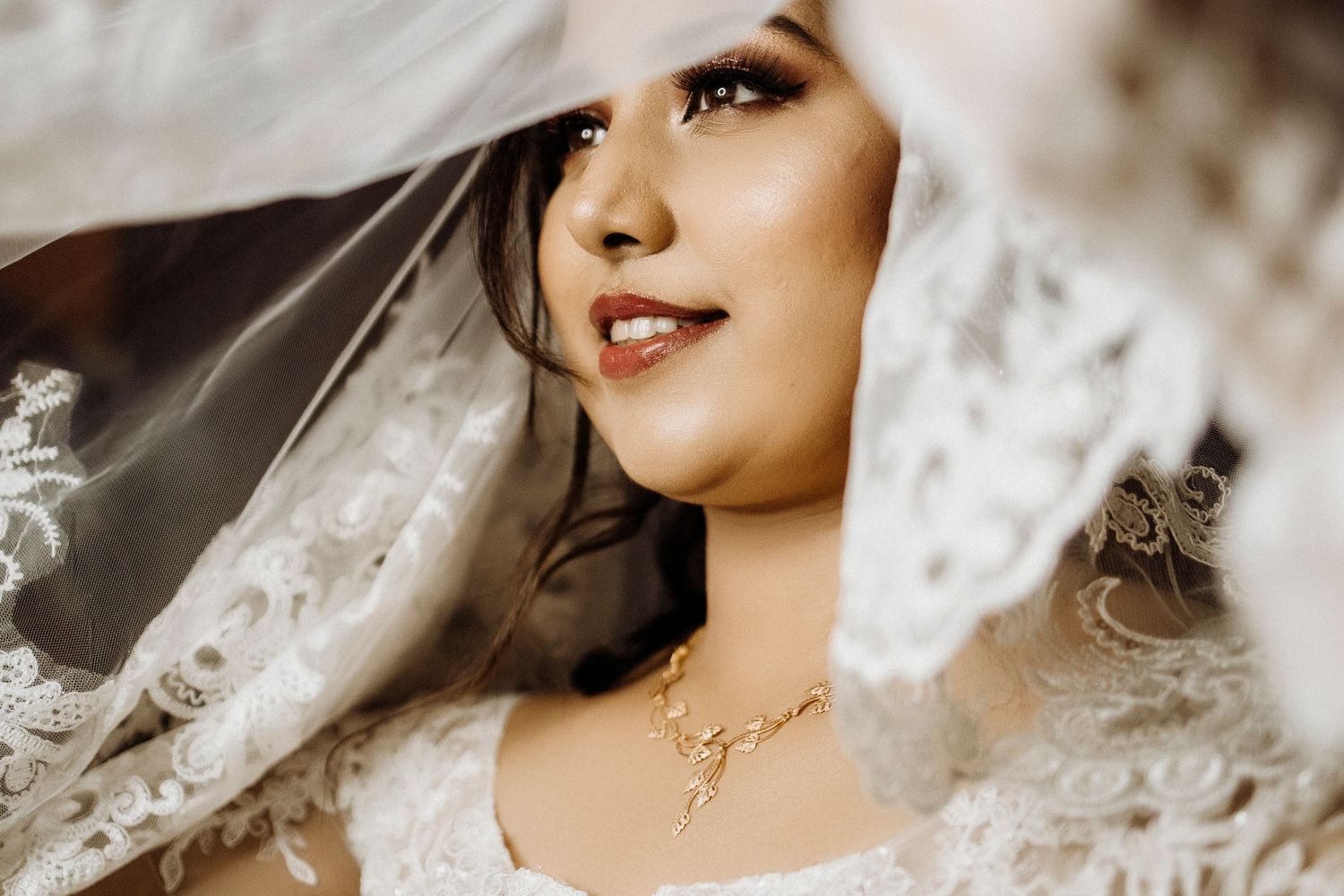 Ethereal bridal portrait featuring intricate lace details and soft lighting.