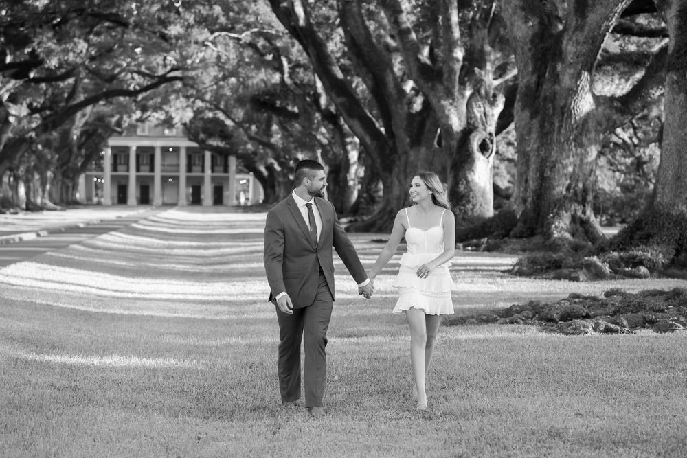 Black and white panoramic series of couple walking together on scenic grounds.