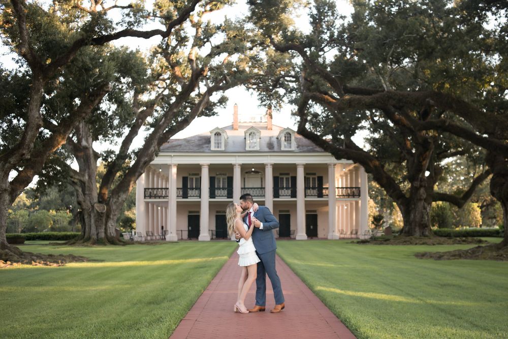 Wide panoramic views of a historic southern mansion with oak trees and manicured lawns.