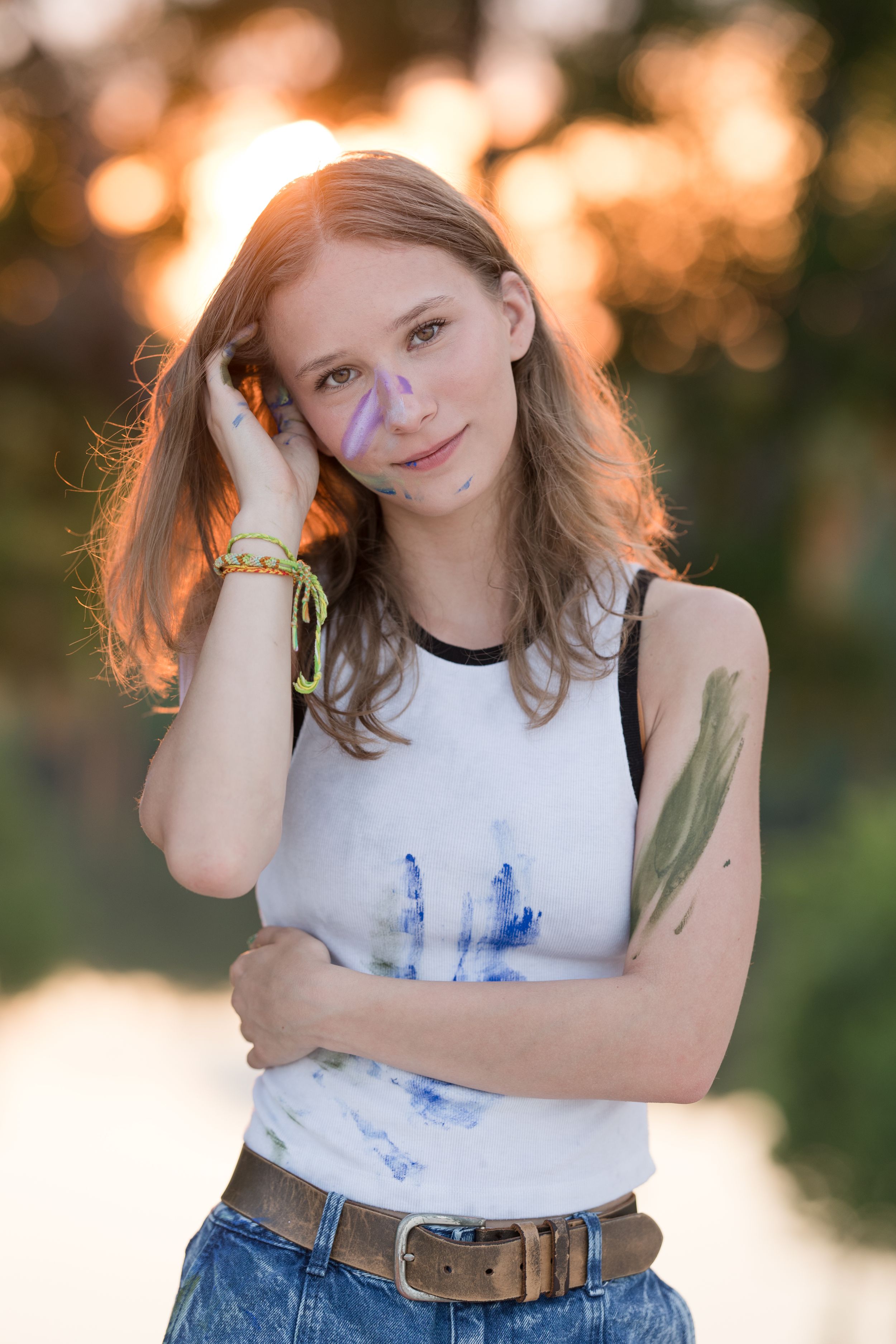Outdoor portrait session at golden hour featuring artistic poses against a natural backdrop.