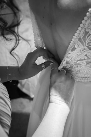 Close-up detail shot of wedding dress being fastened.