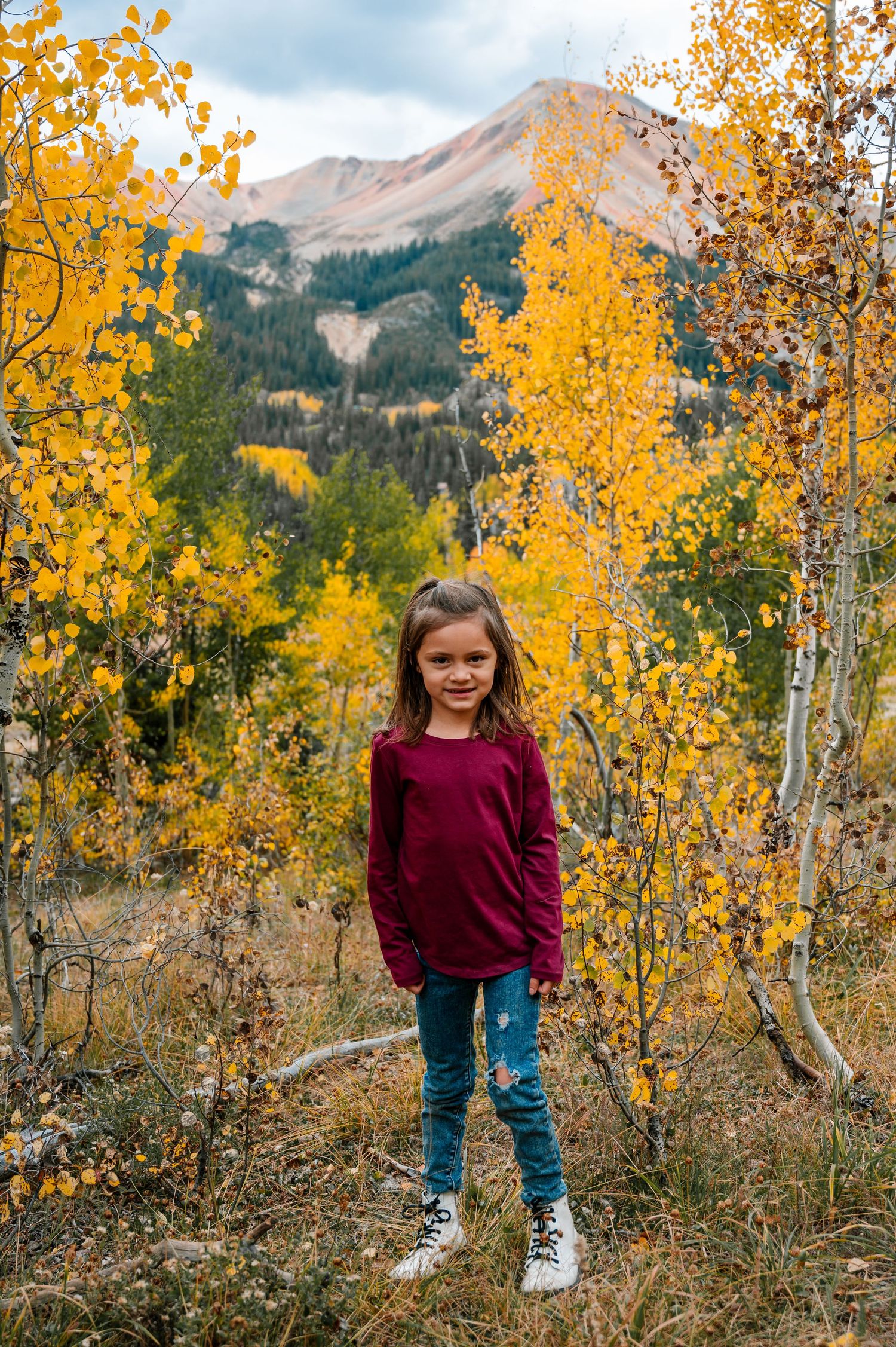 Scenic mountain landscape with vibrant yellow aspen trees during peak fall colors.