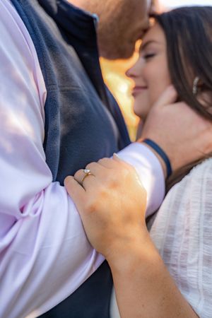 A close-up of hands clasped together during a romantic dance moment.