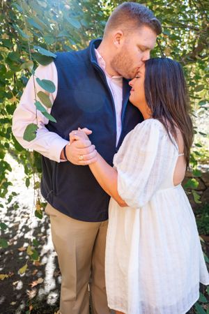A couple dances together during their outdoor engagement photo session.