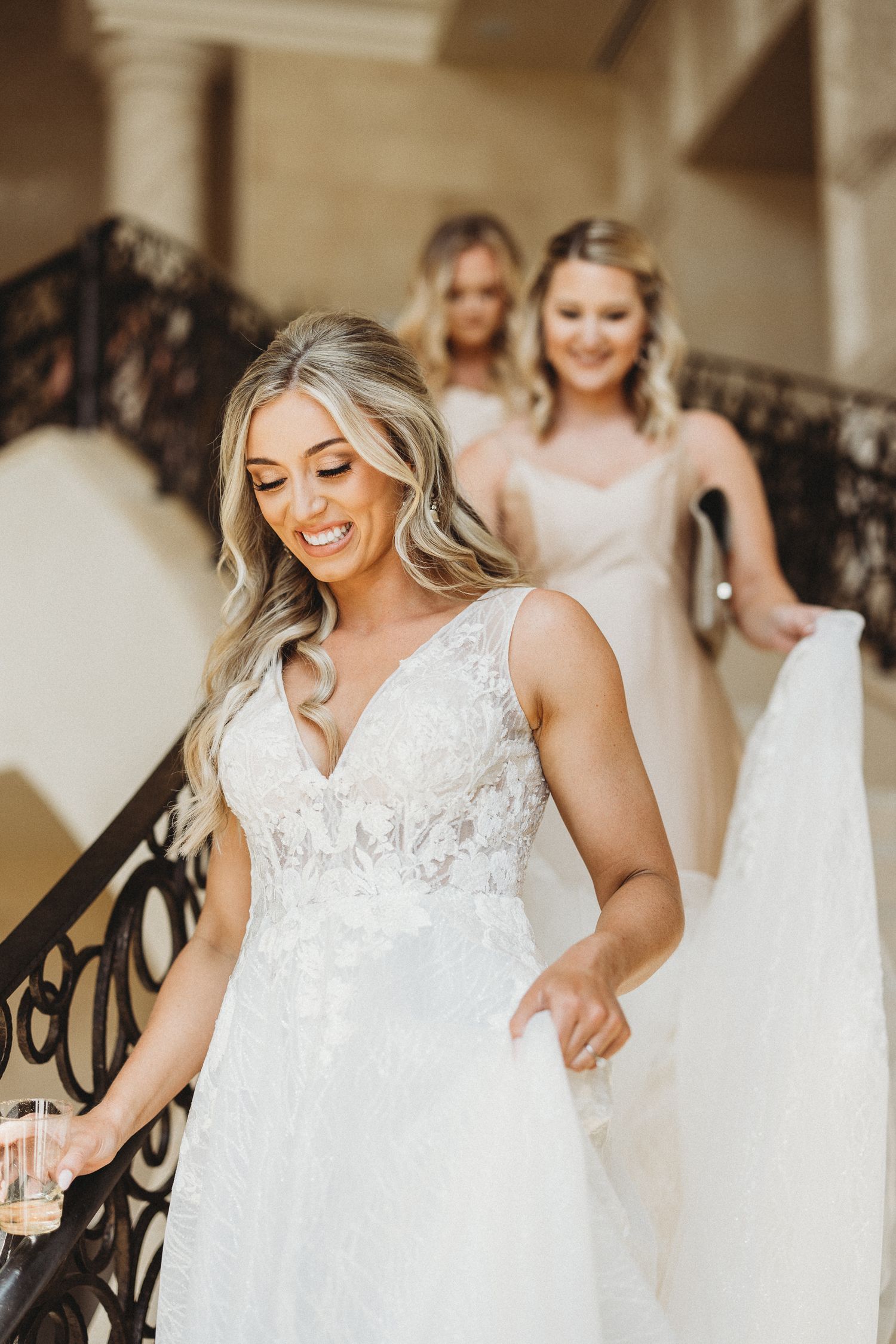 Bride and her bridesmaids descending The Four Seasons grand staircase for her wedding.