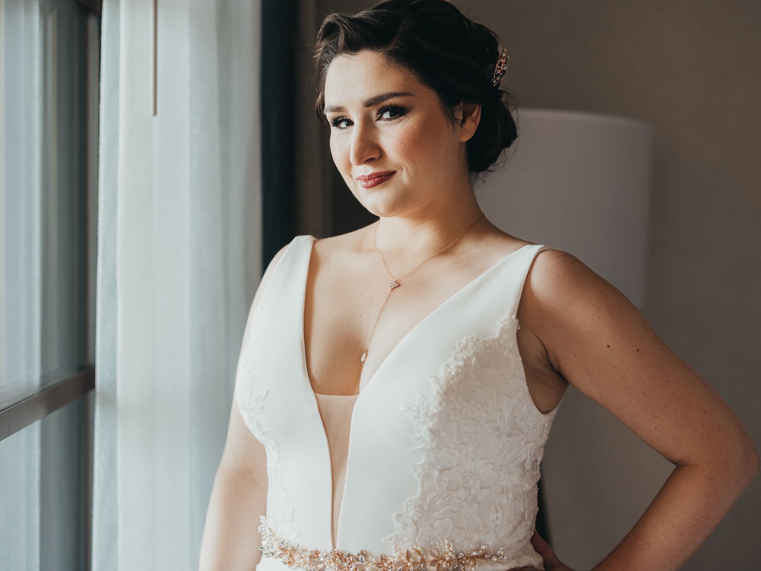 Bride looking out window at her future in Kissimmee.