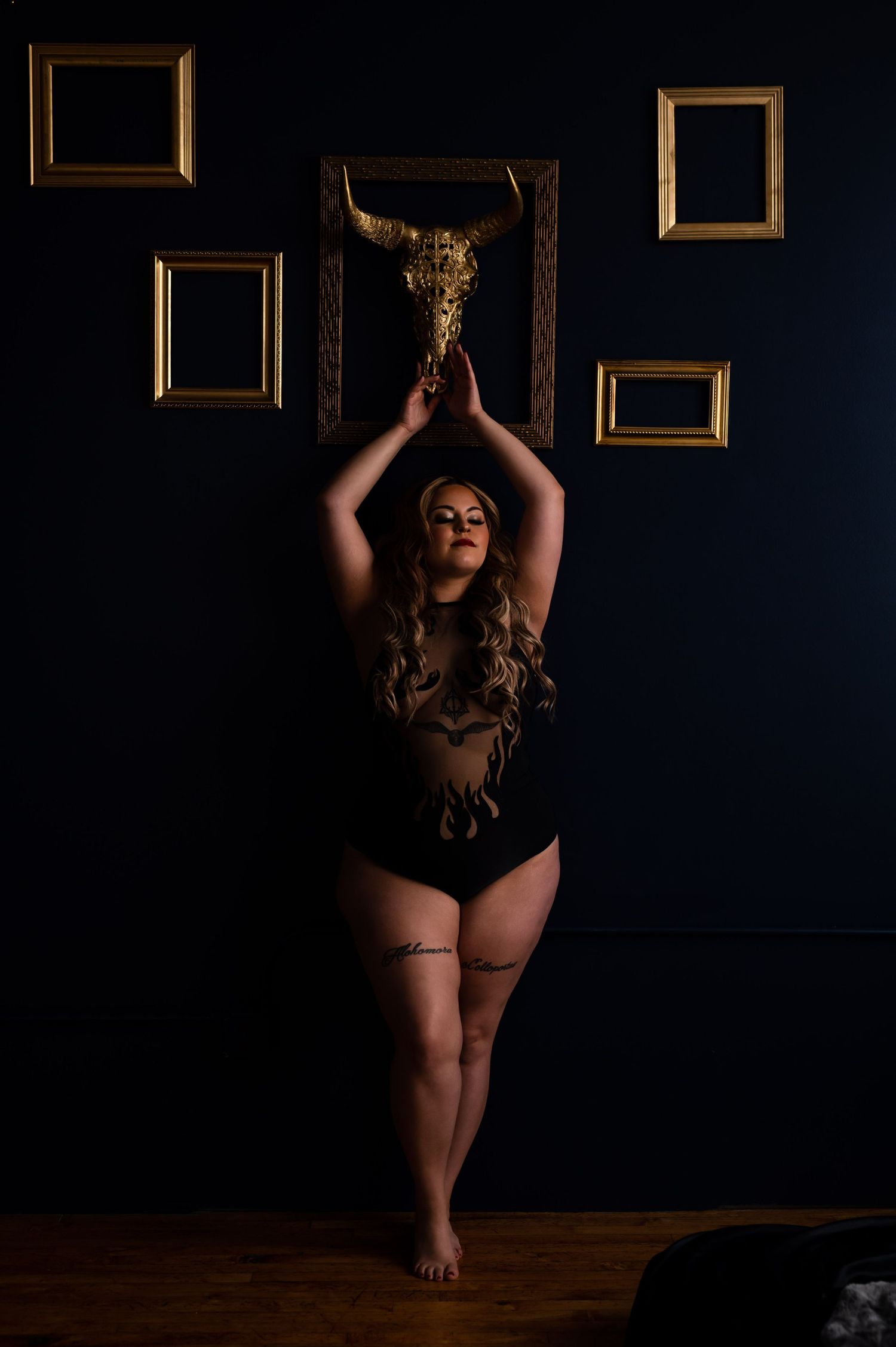 Confident plus-size woman in black lingerie during a boudoir photoshoot in Buffalo NY