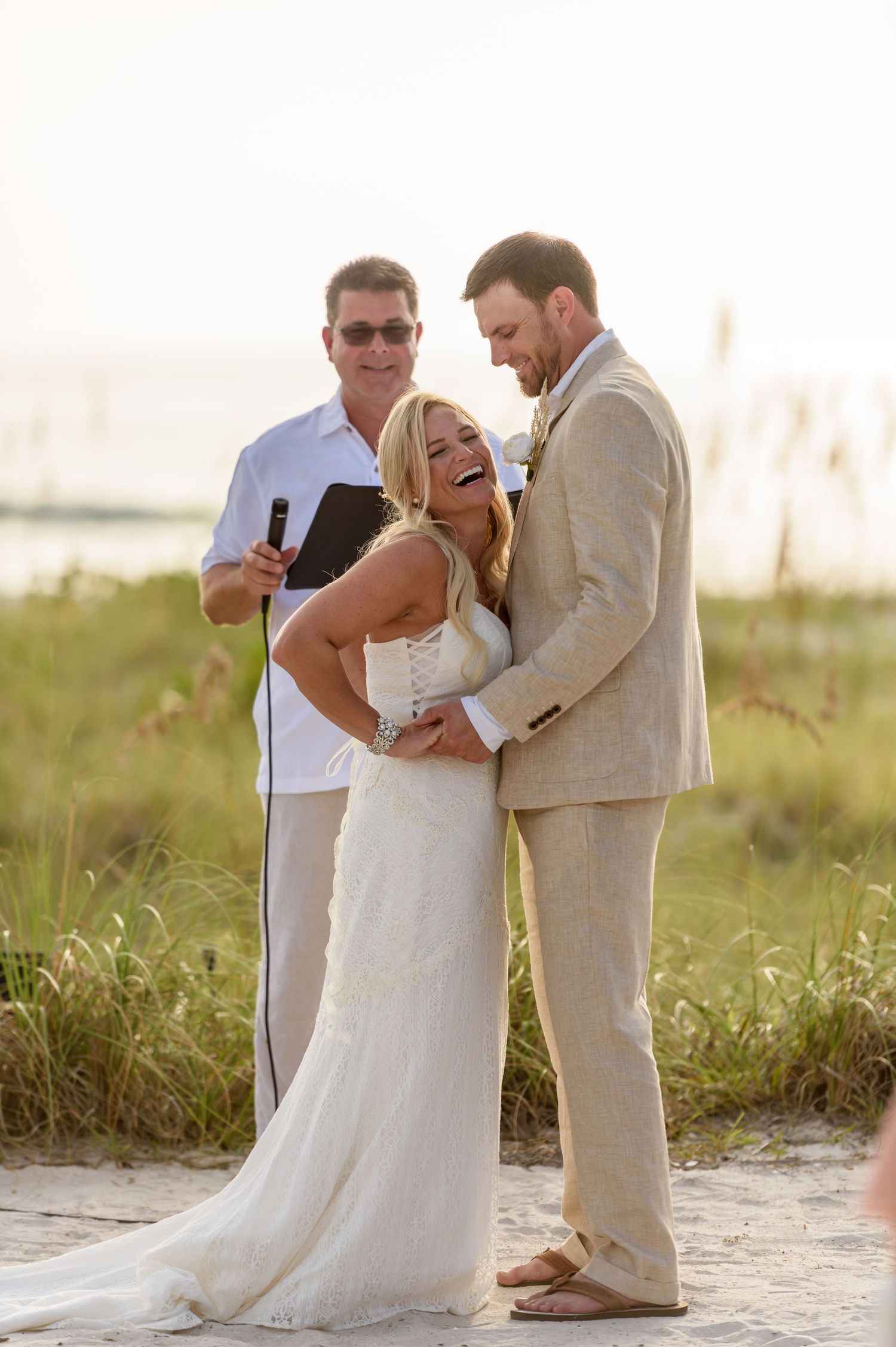 Bride laughing next to groom.