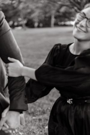 Black and white images of playful moments between two people in a park.