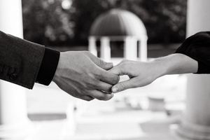 Close-up shots of hands exchanging rings during a romantic moment.