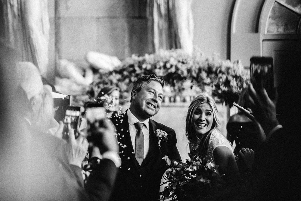 Black and white photograph Lisa Faulkner and John Torode's Wedding at Aynhoe Park Walking down the Isle