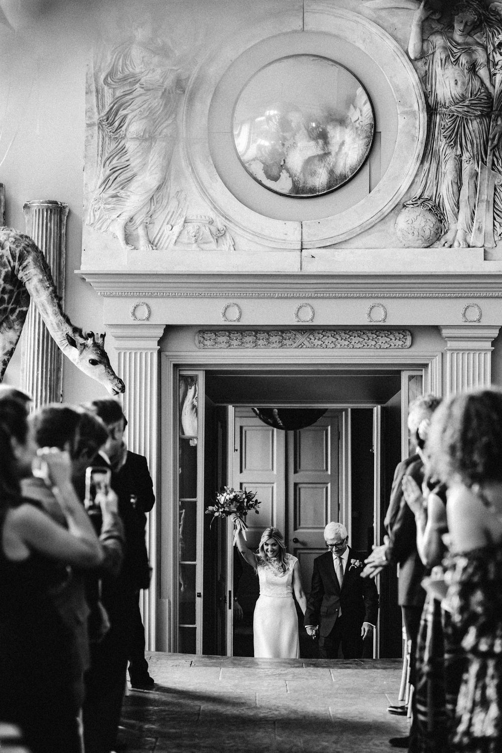 Black and white photograph Lisa Faulkner and John Torode's Wedding at Aynhoe Park Lisa Walking down the Isle happy