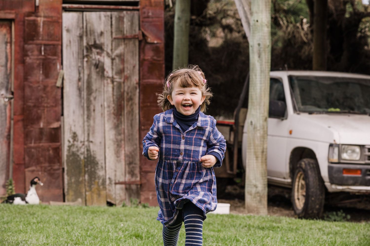 Lifestyle image of a girl running on a farm