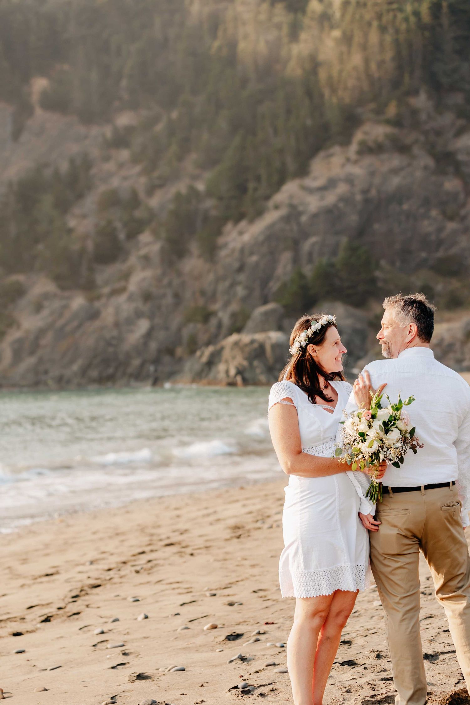 Couple getting photos taken on their wedding day along the beautiful Samuel H. Boardman Corridor outside of Brookings, Oregon