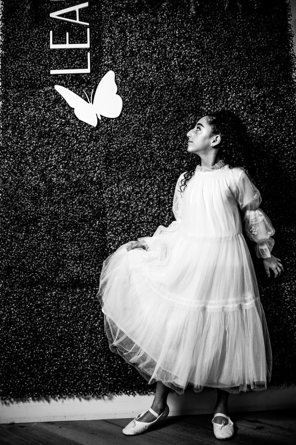 Girl lit up by professional photography equipment at her bat mitzvah photoshoot.