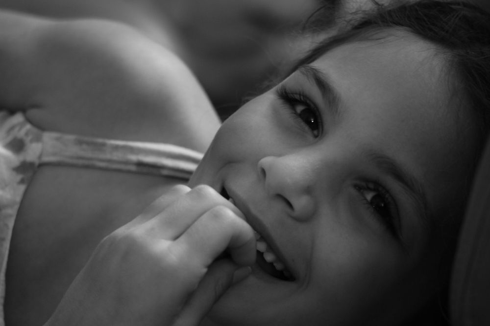 Black and white close-up portrait with soft natural lighting.