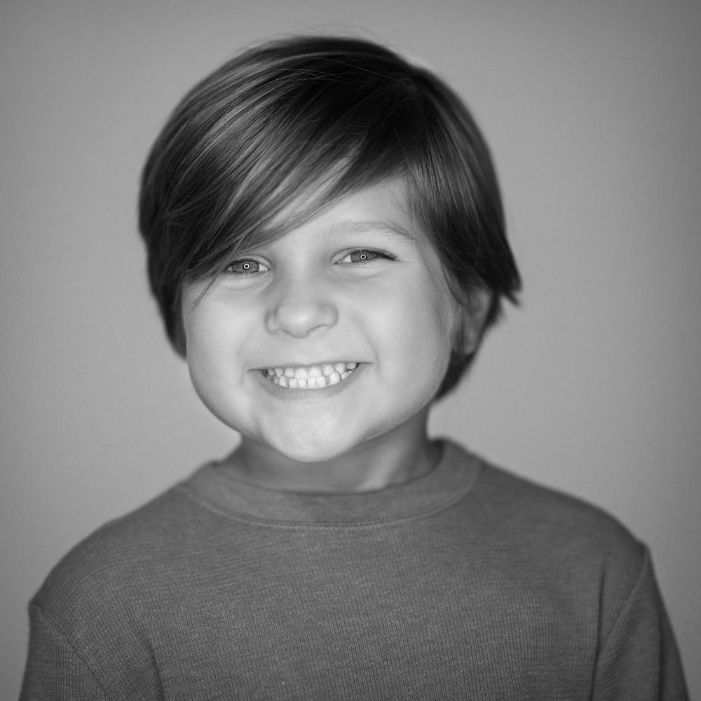 Black and white studio portrait with gentle lighting.