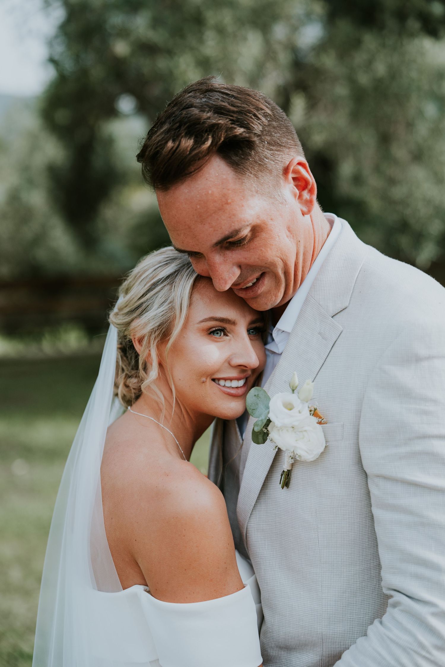 A tender embrace captured during outdoor wedding portraits.