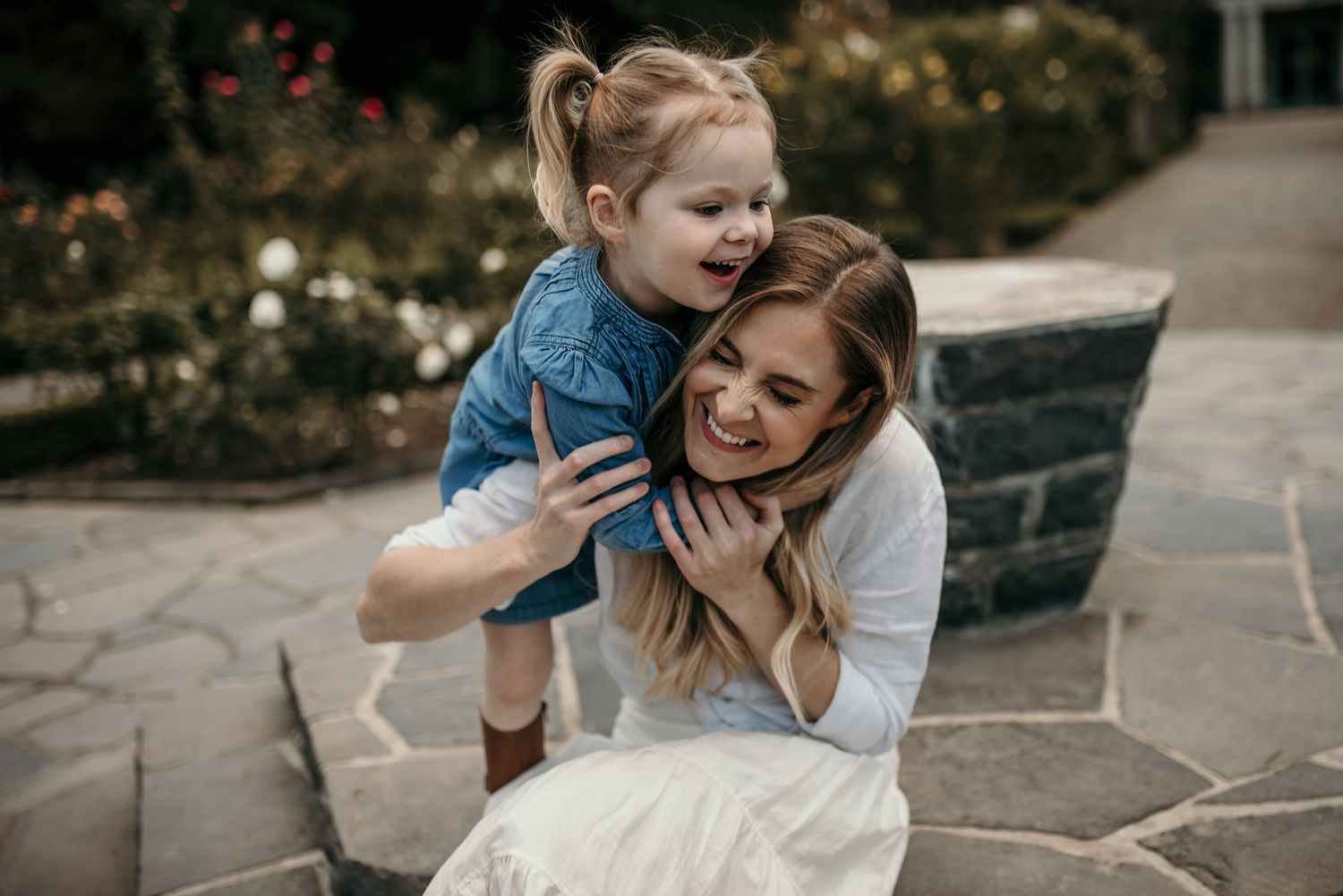 Candid moment of joyful play on stone patio.