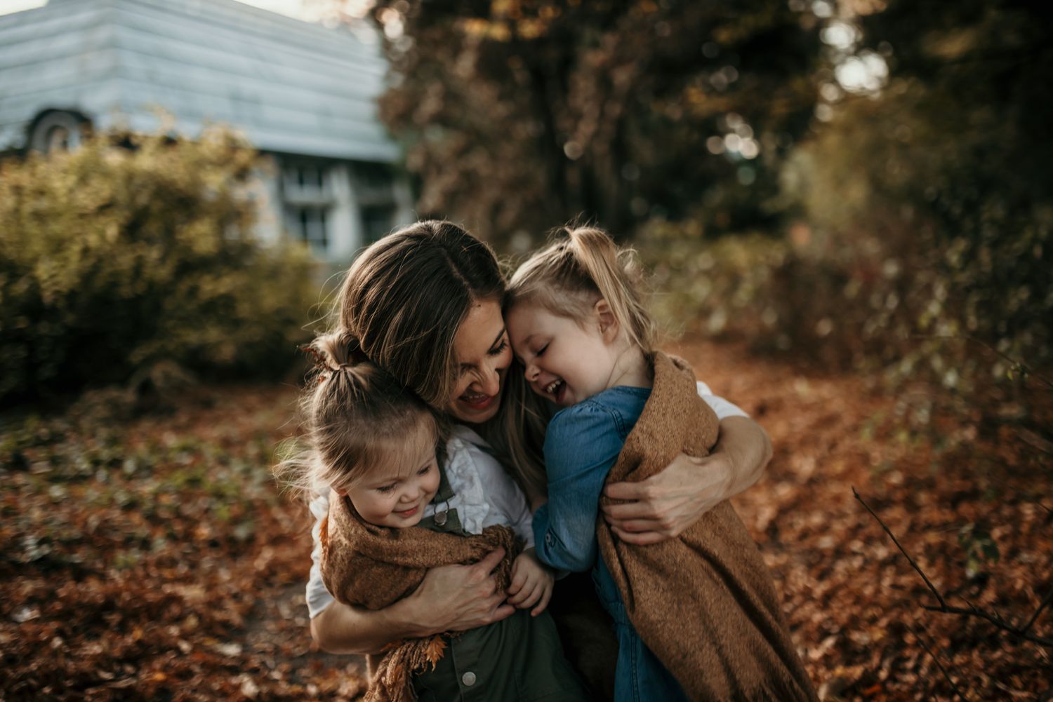 Intimate moment shared between loved ones on an autumn day surrounded by fallen leaves.
