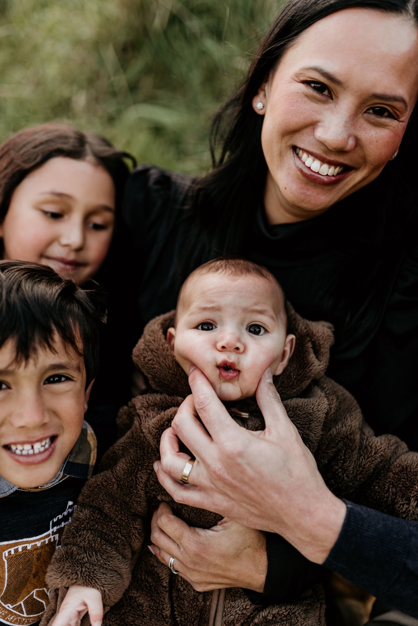 A close-up portrait capturing genuine smiles and happiness in an outdoor setting.