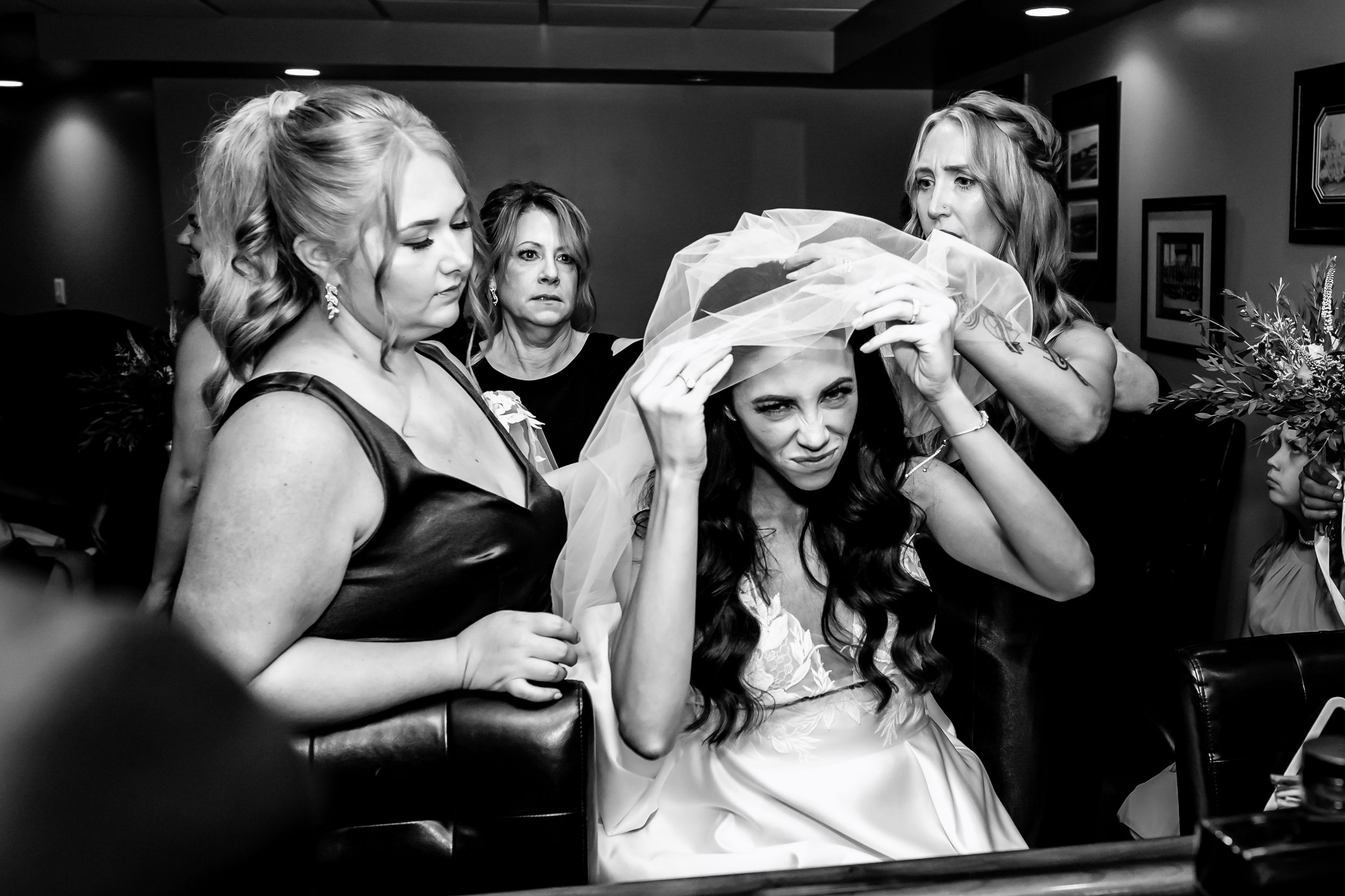 Black and white candid moment of wedding preparation festivities.