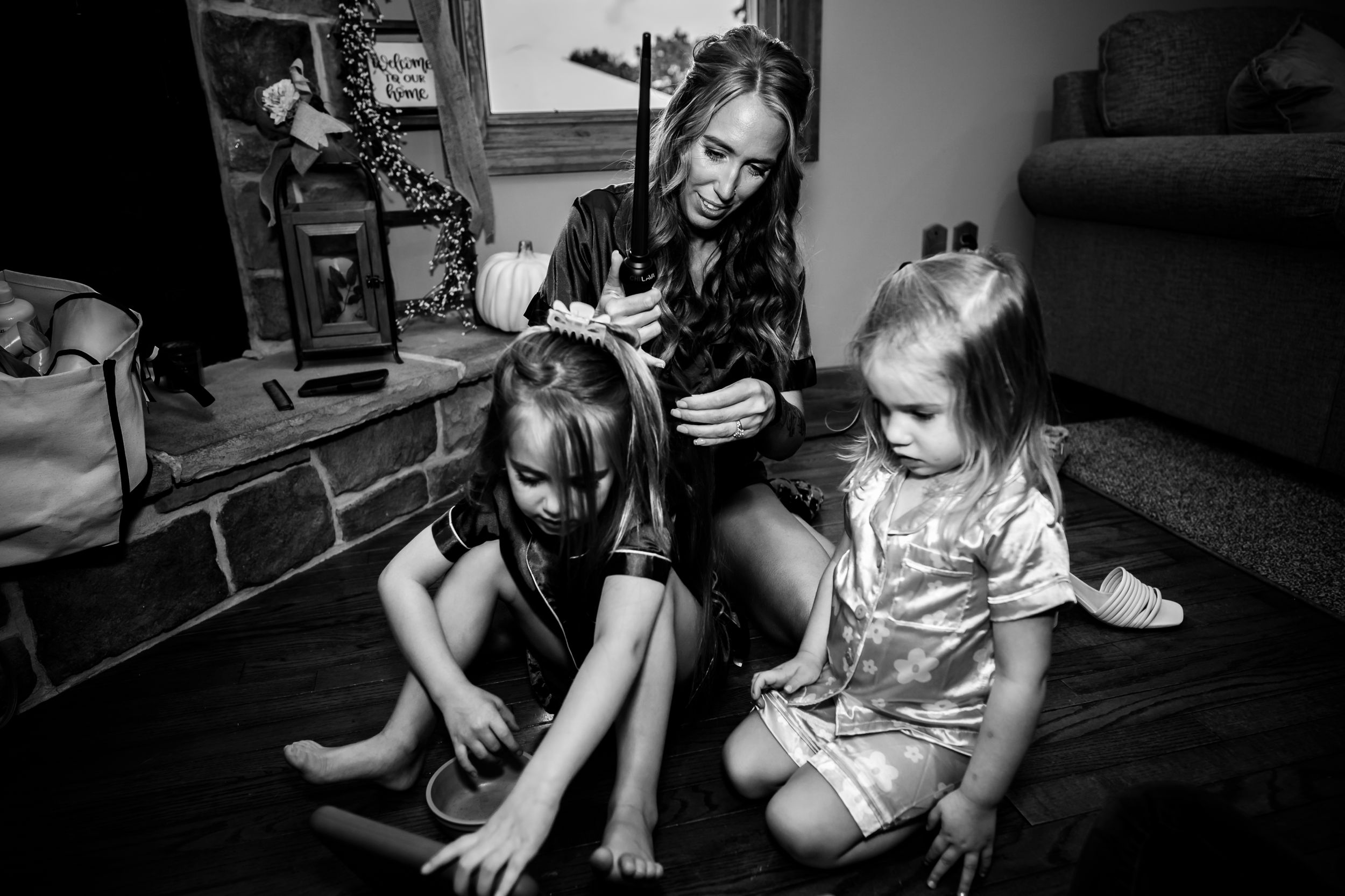 Children playing with toys and electronics in a casual home setting.