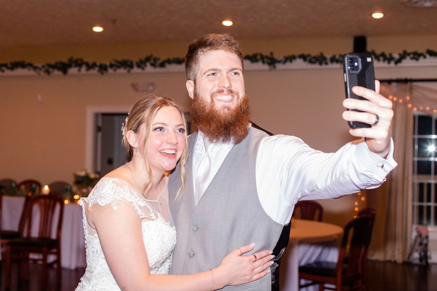 Couples dancing together at an elegant indoor wedding reception.