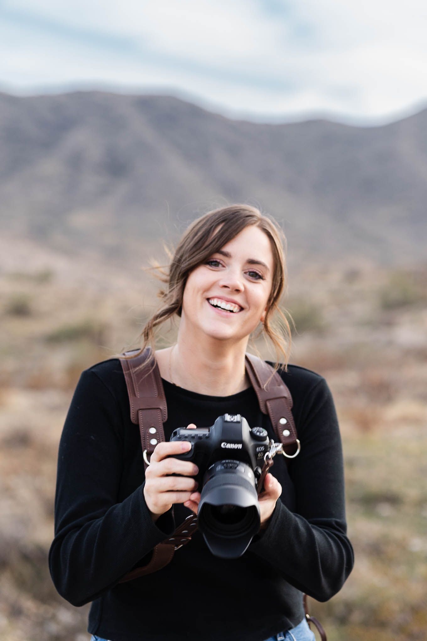 Minnesota Wedding Photographer Shania Hirdler smiling and holding her camera in a self portrait