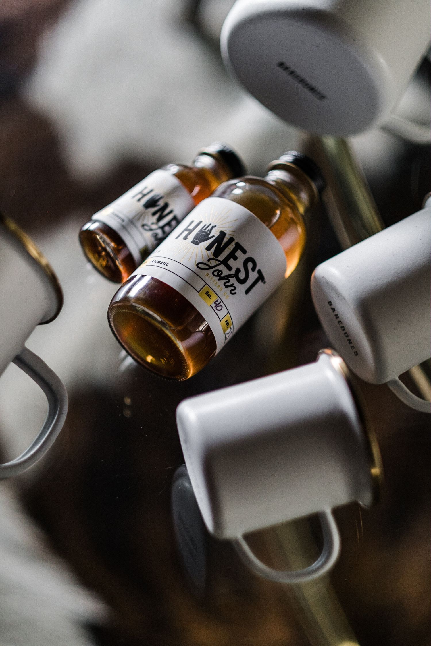Collection of white labeled bottles arranged in an artistic diagonal pattern.