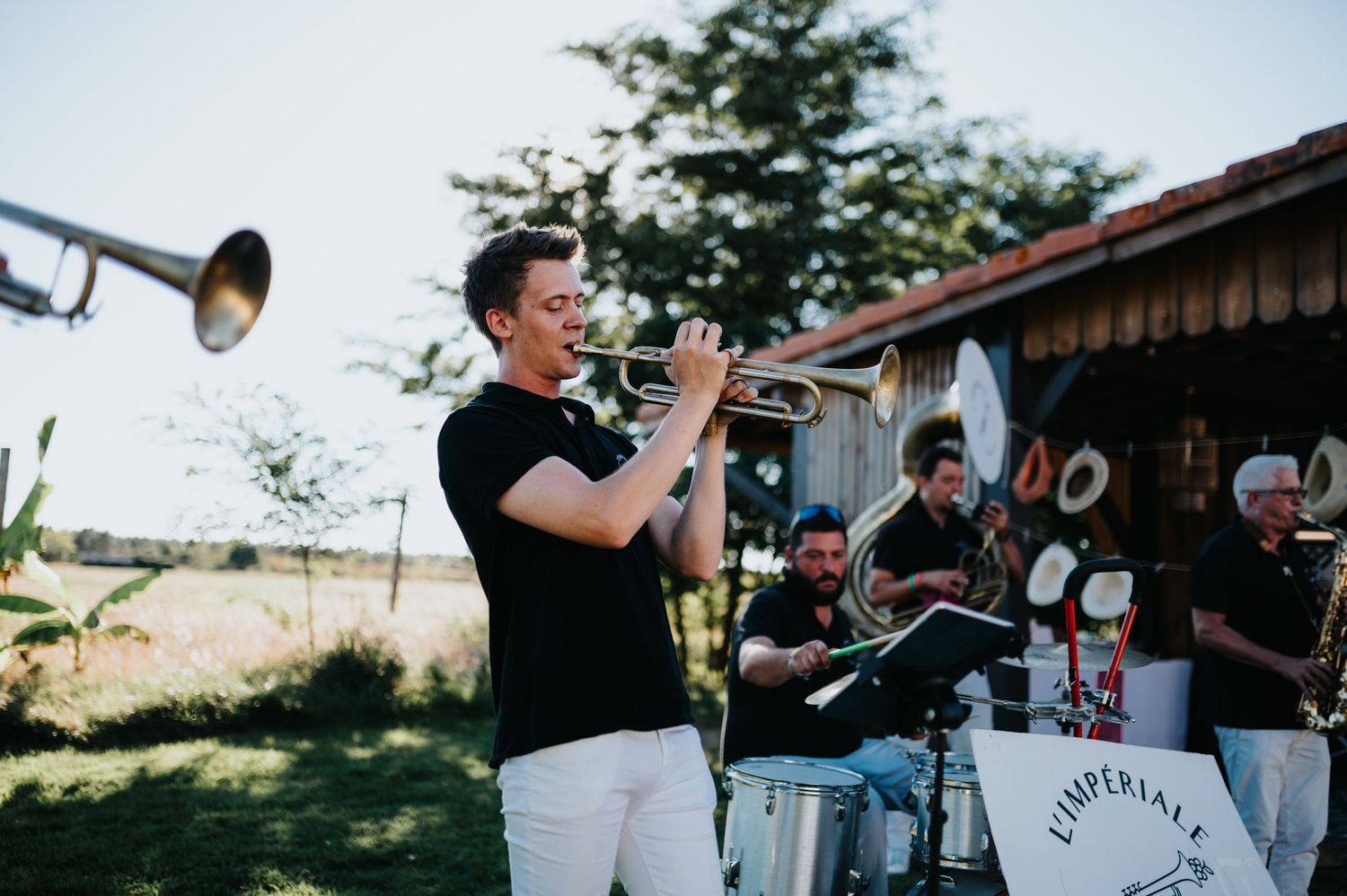 Brass band performs at outdoor wedding celebration.
