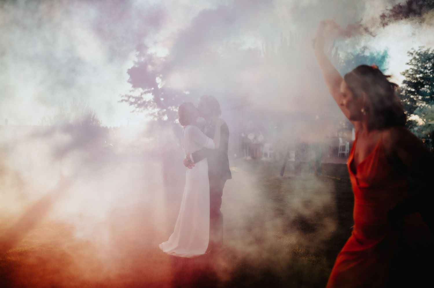 Atmospheric smoke effects create a dreamy outdoor scene with silhouettes.