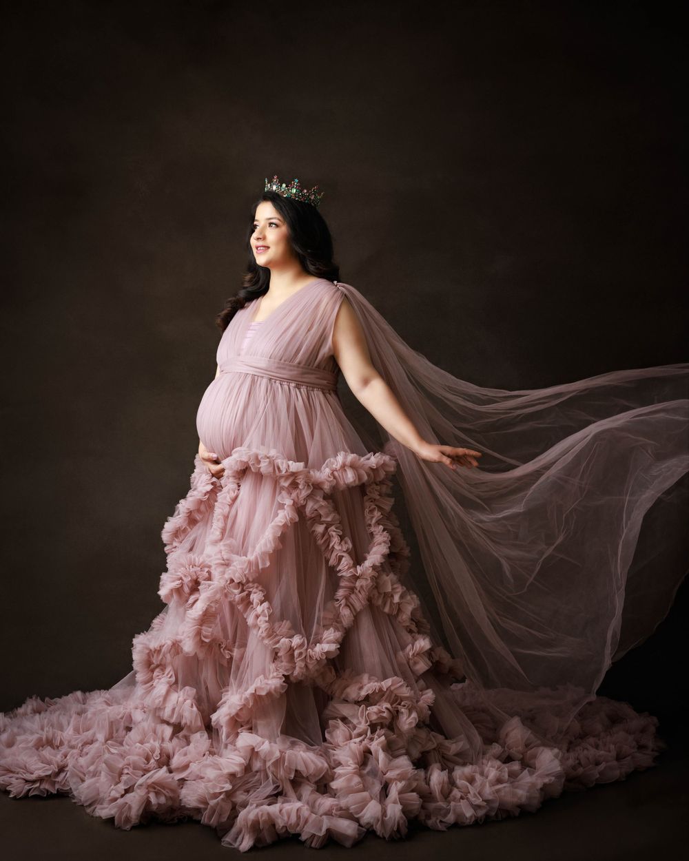 Dreamy maternity portrait in flowing dusty rose gown with crown.