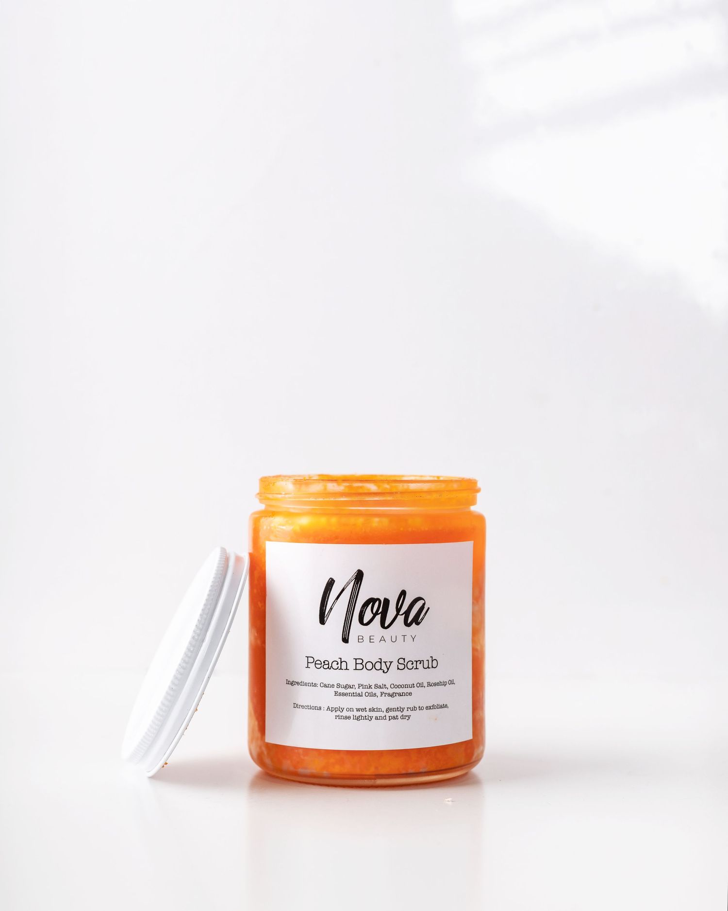 <img src="body scrub.png" alt="bottle of orange sugar scrub with lid open">