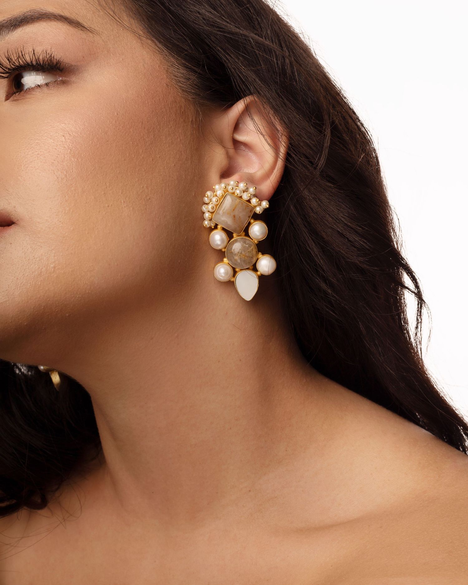 <img src="earrings.png" alt="model wearing gem earrings with curly hair">