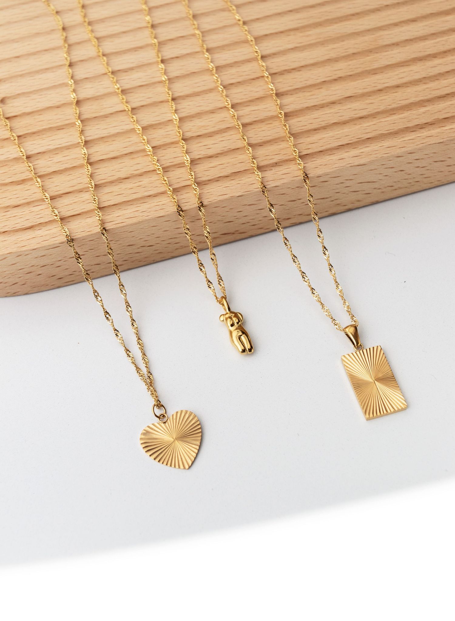 <img src="waterproof jewellery.png" alt="product image of three golden chains on white background">